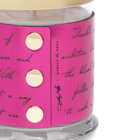 Close-up view of the candle jar showcasing the label typography and vibrant hot pink color