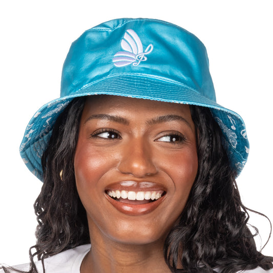 Folded blue satin bucket hat resting on a neutral surface