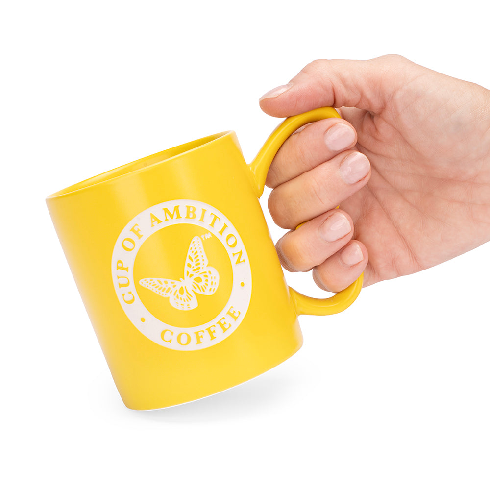 Close-up view of the laser-etched finish and yellow glaze on the mug surface