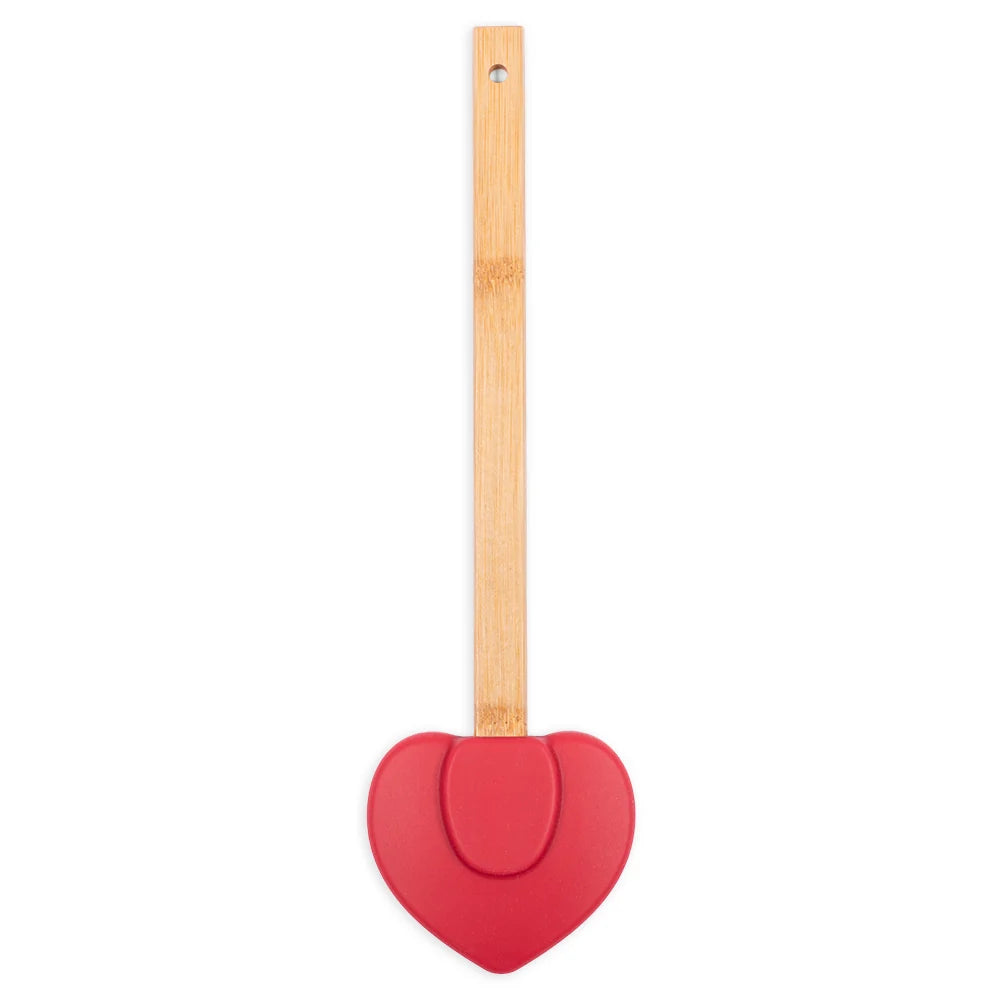 Close-up view of the spatula handle and heart graphic design against a clean kitchen background