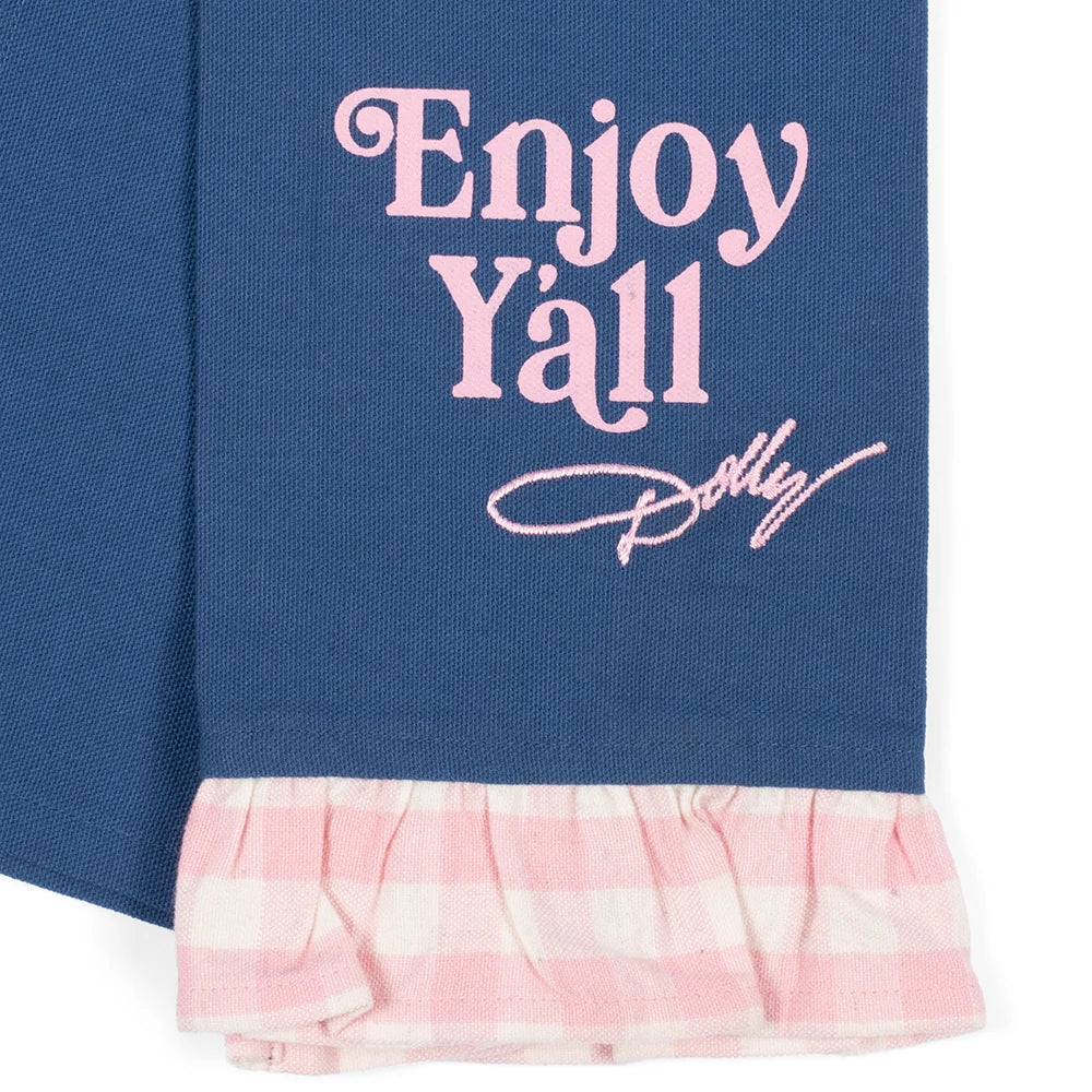 Full view of the Dolly Parton tea towel laid flat, showing the complete Good Lookin' Cookin' graphic and gingham border