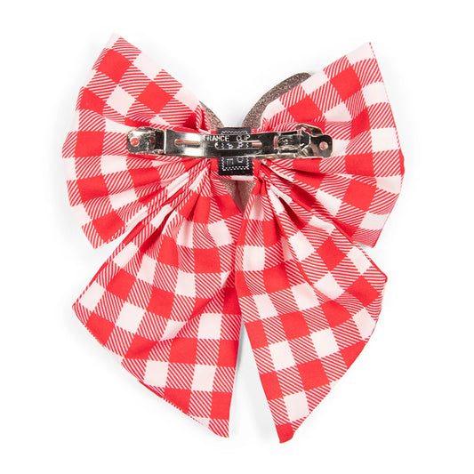 Close-up detail of the gingham pattern and butterfly motif on the hair bow