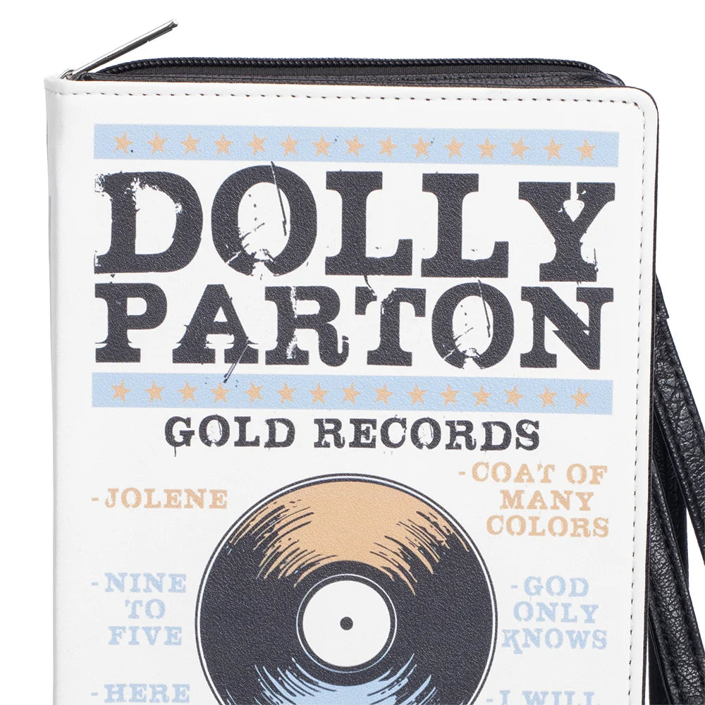 Lifestyle view of the Dolly Parton wristlet held in hand, showing scale and strap