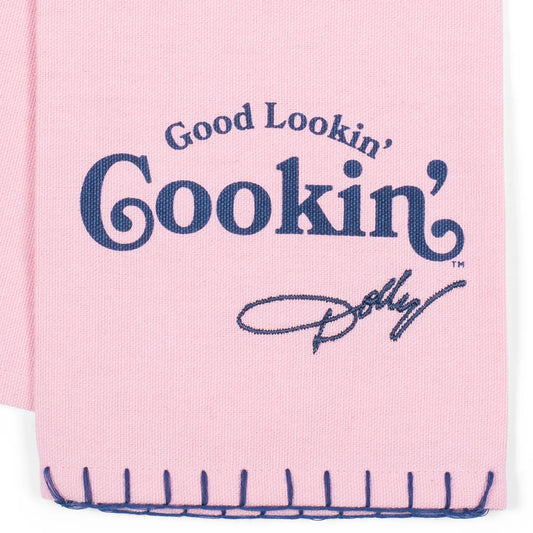 Close-up view of the folded Dolly Parton tea towel showing the decorative typography and border details