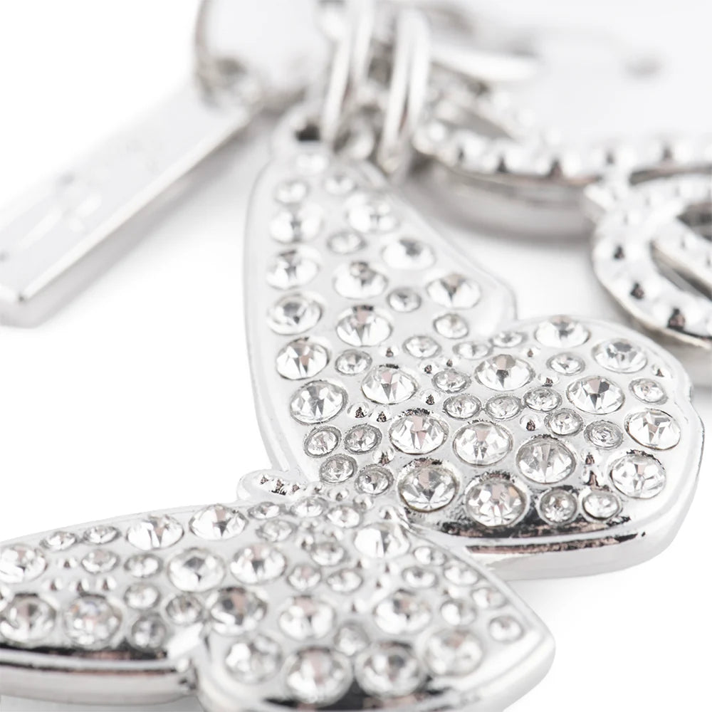 Close-up view of the polished silver butterfly charm featuring intricate wing details
