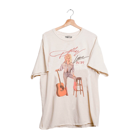 Load image into Gallery viewer, Official Dolly Parton Merchandise. This t-shirt features a vintage photo of Dolly holding an acoustic guitar.
