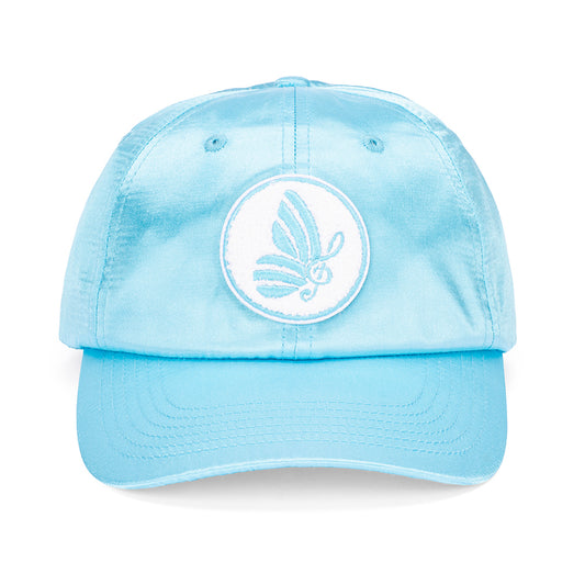 Close-up angle of the blue satin fabric texture on the Dolly Parton cap