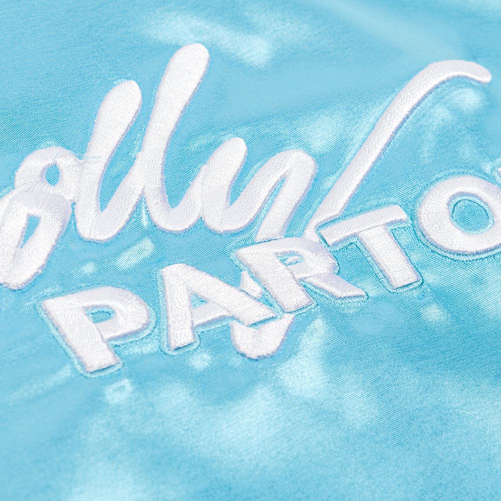 Close-up of the smooth satin fabric texture on the blue tour jacket