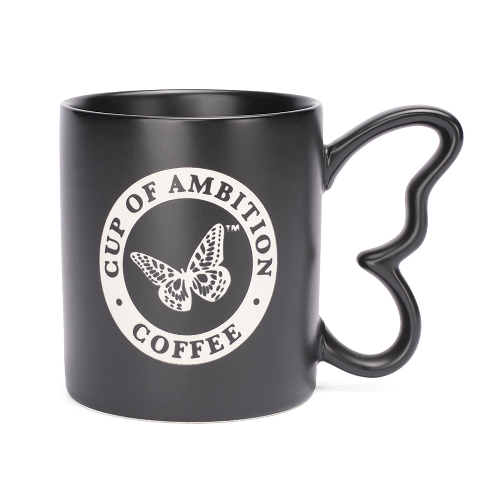 Black ceramic coffee mug featuring a laser-etched design and a unique butterfly-shaped handle, shown from the front view.