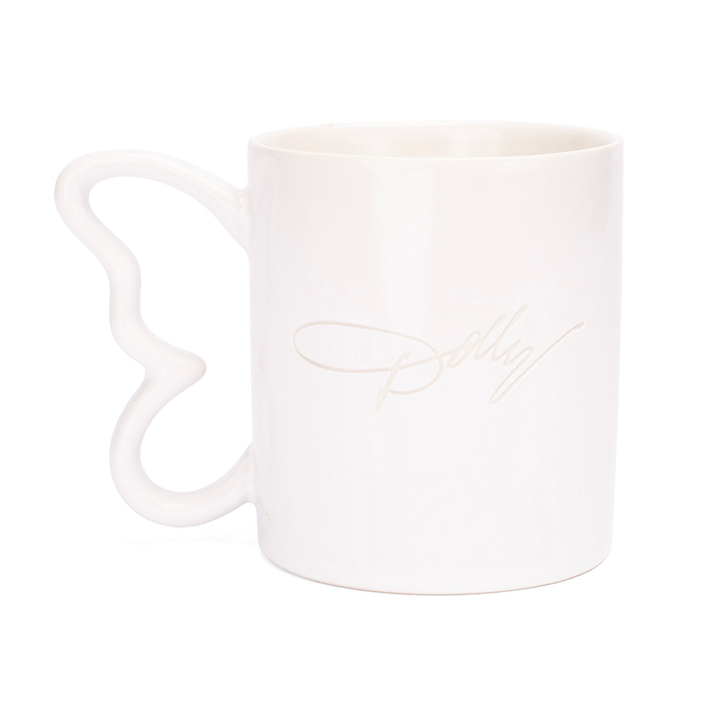 Close-up of the sculpted butterfly handle on the white ceramic mug