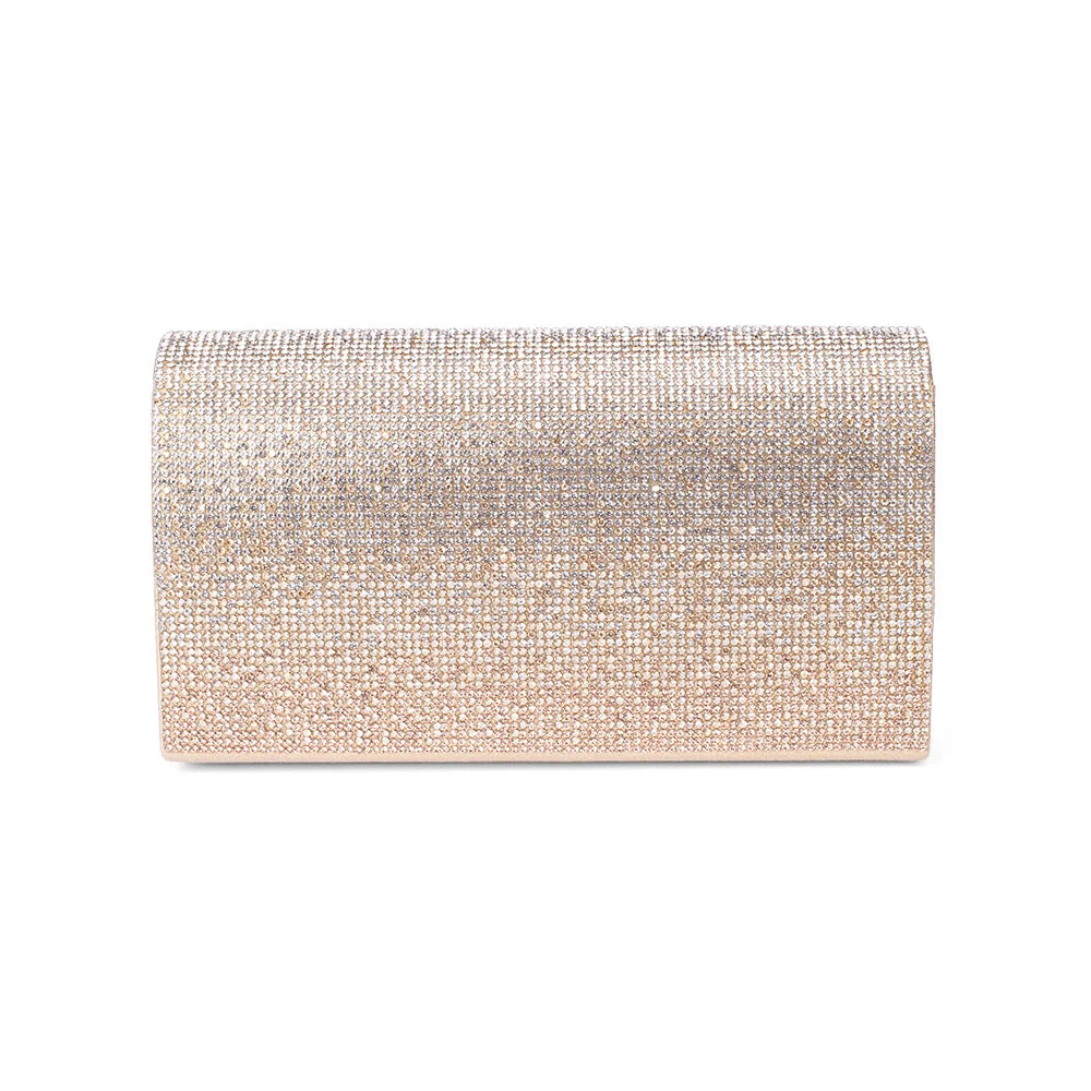 Lifestyle view of the gold glam clutch styled for an evening out