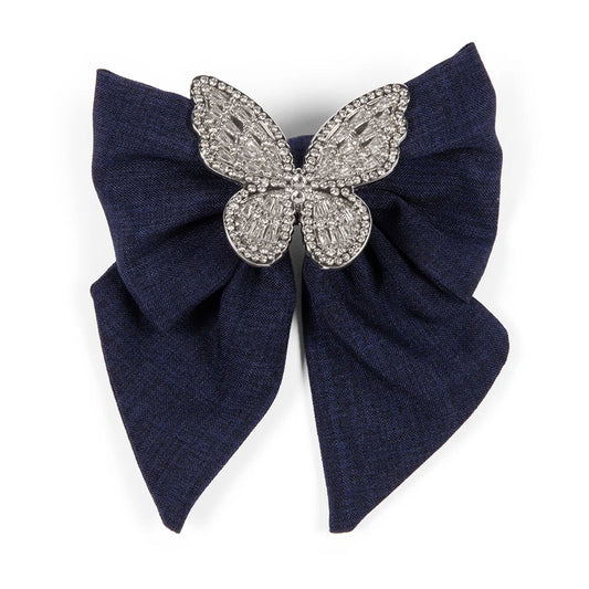 Denim hair bow featuring an embroidered country butterfly motif, front view