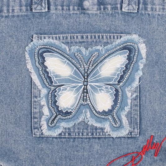 Close-up detail of the butterfly motif on the denim handbag