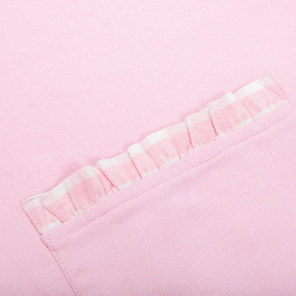 Folded pink apron showing the neckline strap and waist ties