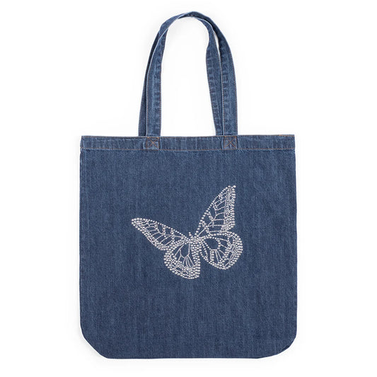 Front view of a blue denim tote bag featuring a large sparkling rhinestone butterfly design centered on the front