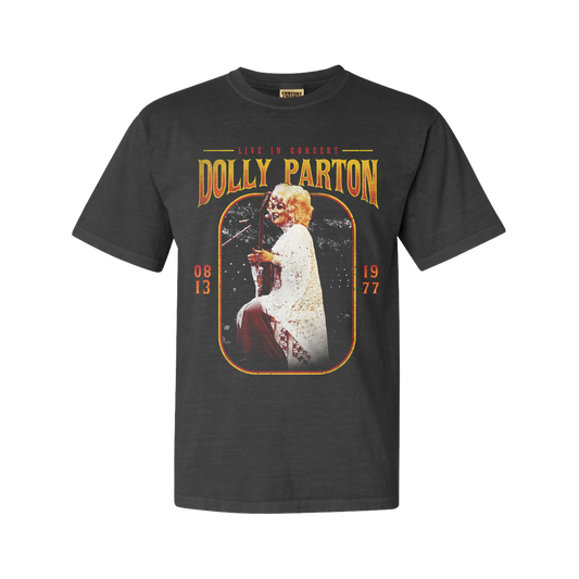 Official Dolly Parton Merchandise. Premium 100% grey cotton unisex t-shirt with a vintage 70's live photo of Dolly Parton playing guitar in white crocheted dress.