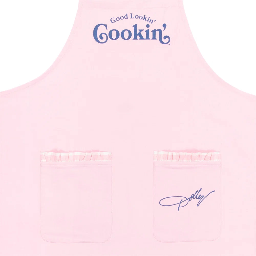 Close-up view of the pink fabric and white Good Lookin' Cookin' text on the apron