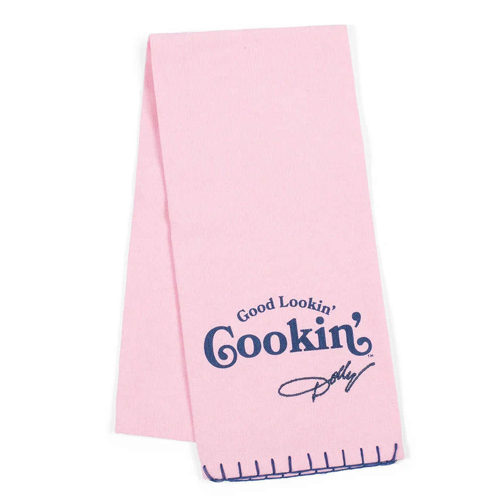 Dolly Parton tea towel featuring the text Good Lookin Cookin in colorful lettering against a neutral fabric background