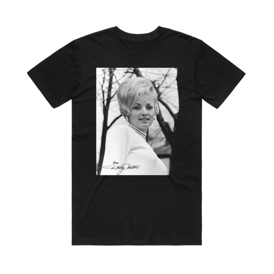 Official Dolly Parton Merchandise. 100% black premium cotton unisex t-shirt with a black and white photo of a young Dolly Parton with 60's style hair and the words "Love Dolly" on the bottom corner of the photo.